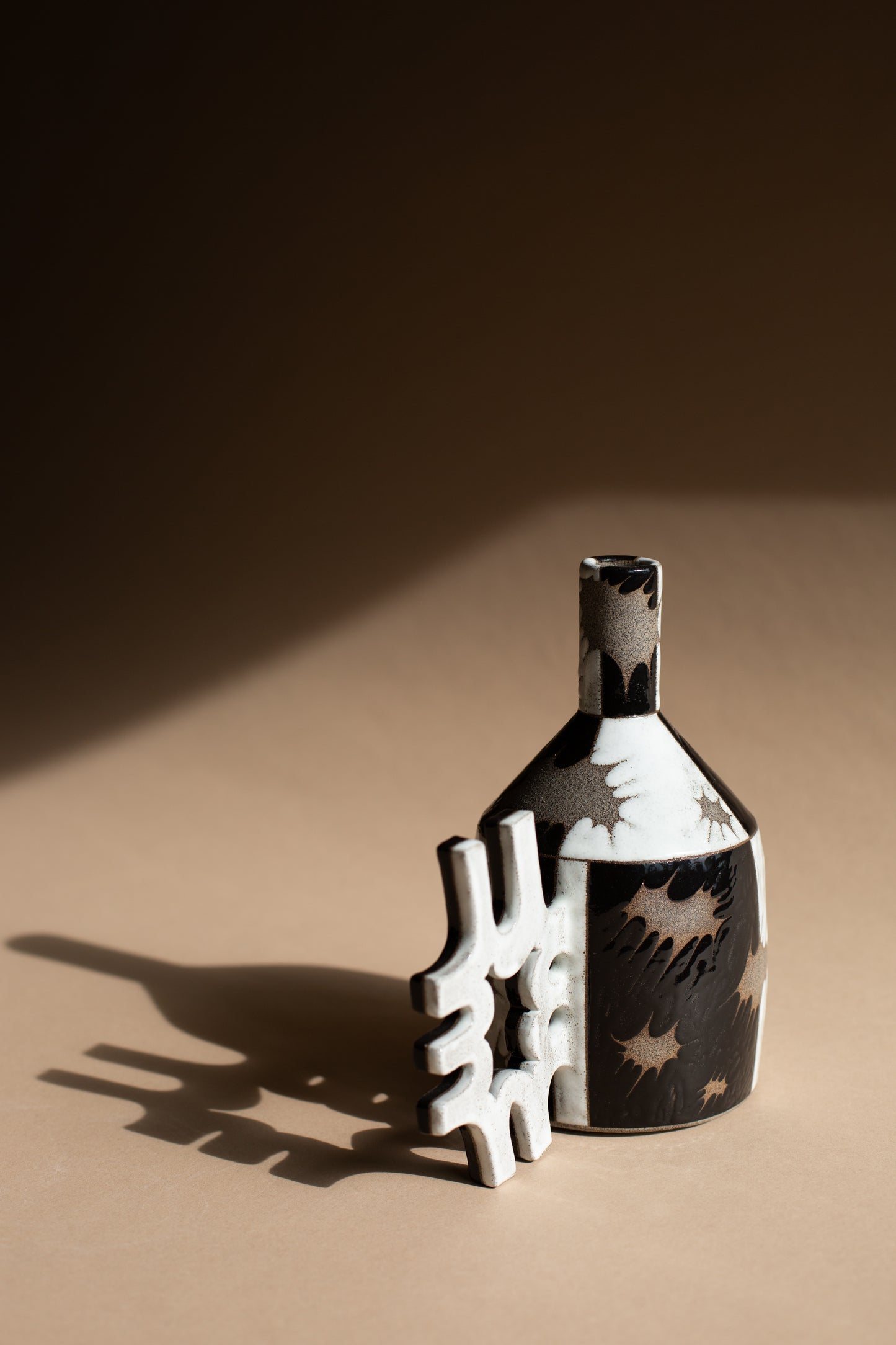 Spiky black + white oil-jug
