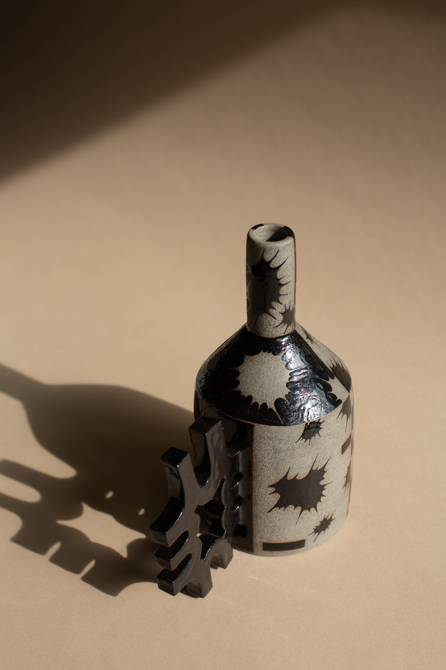 Spiky black oil-jug