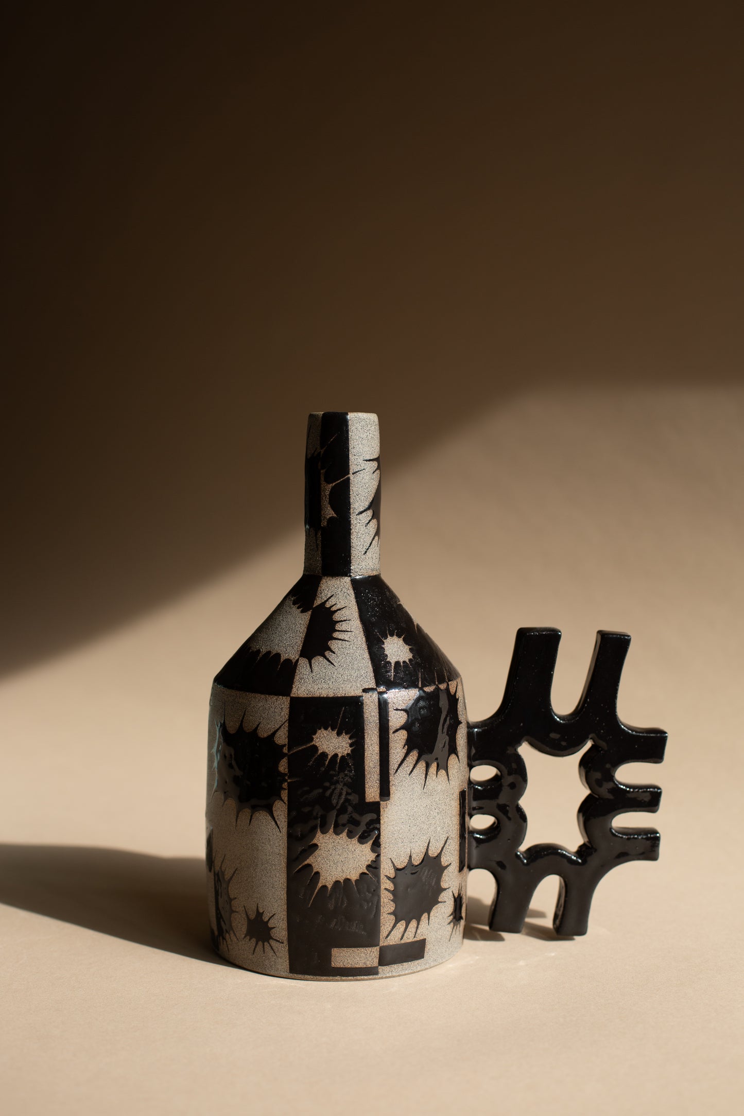 Spiky black oil-jug