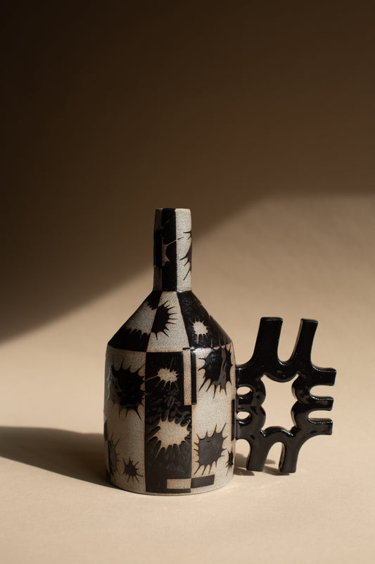 Spiky black oil-jug