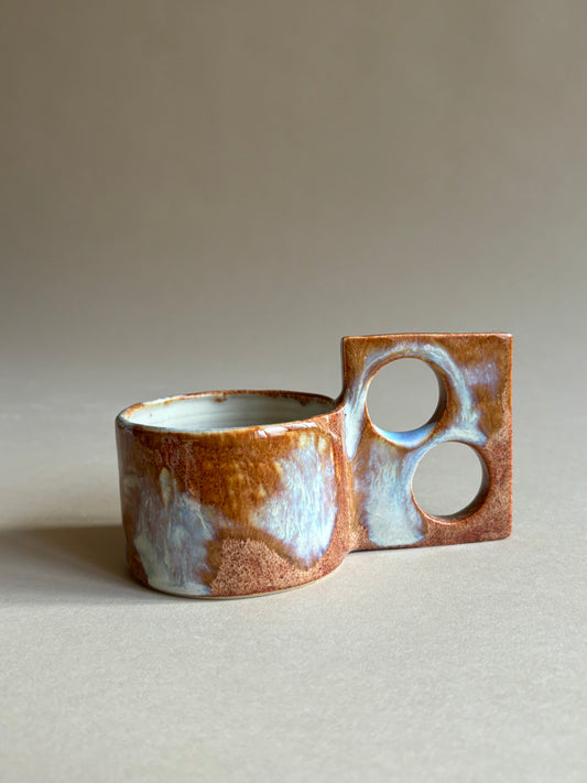 fiery mug with a funky double handle