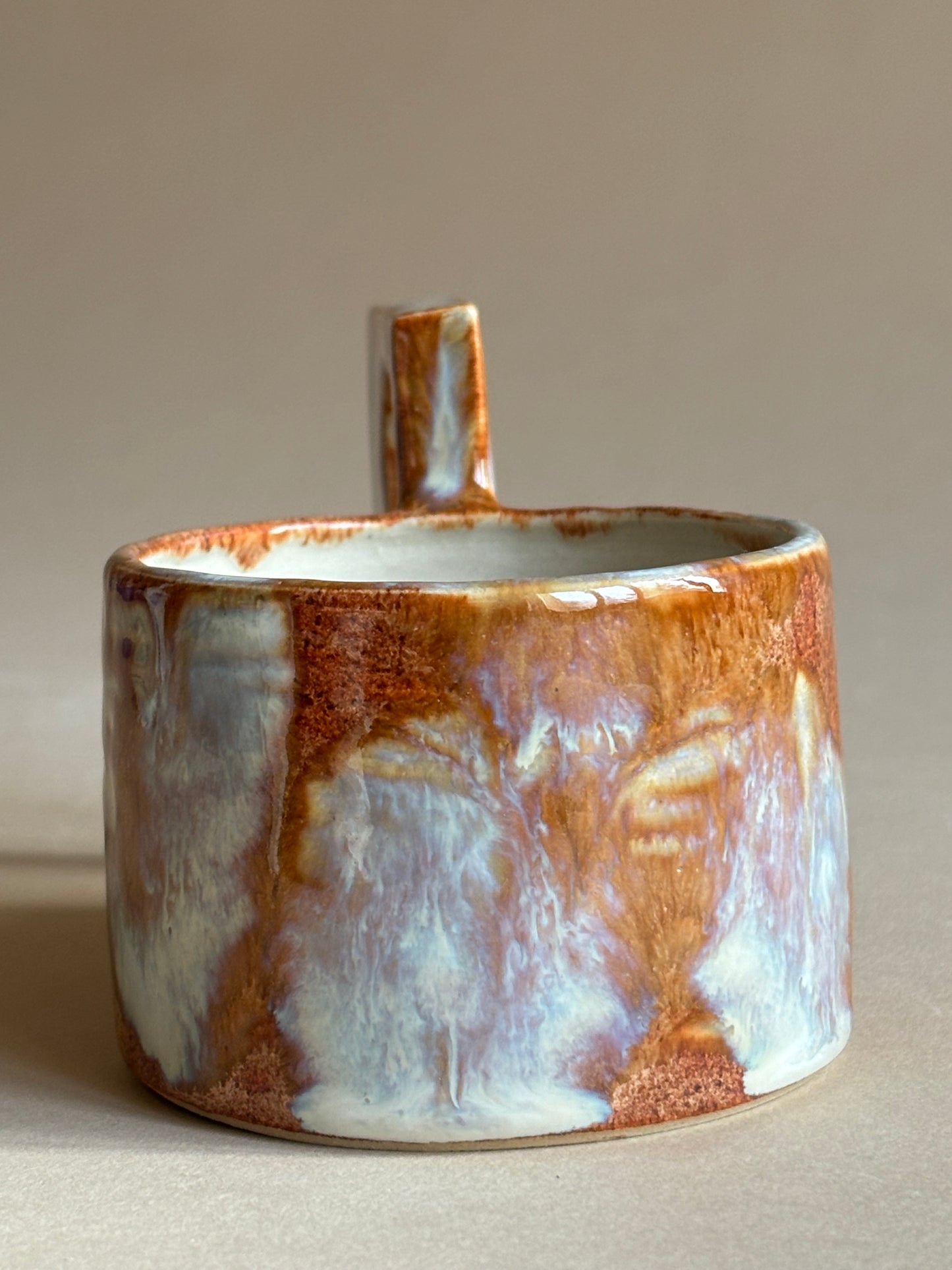 fiery mug with a funky double handle