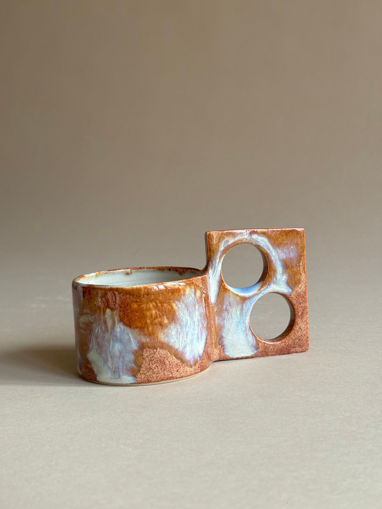 fiery mug with a funky double handle